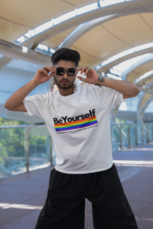 Man wearing the Be Yourself graphic tee with a rainbow pride flag.